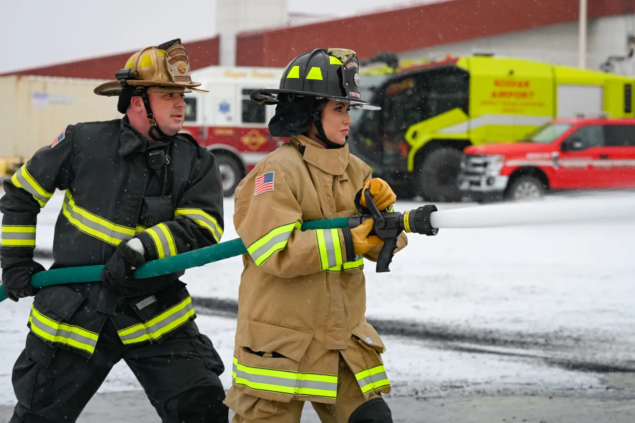 Barbie showing she can handle a hose like a pro